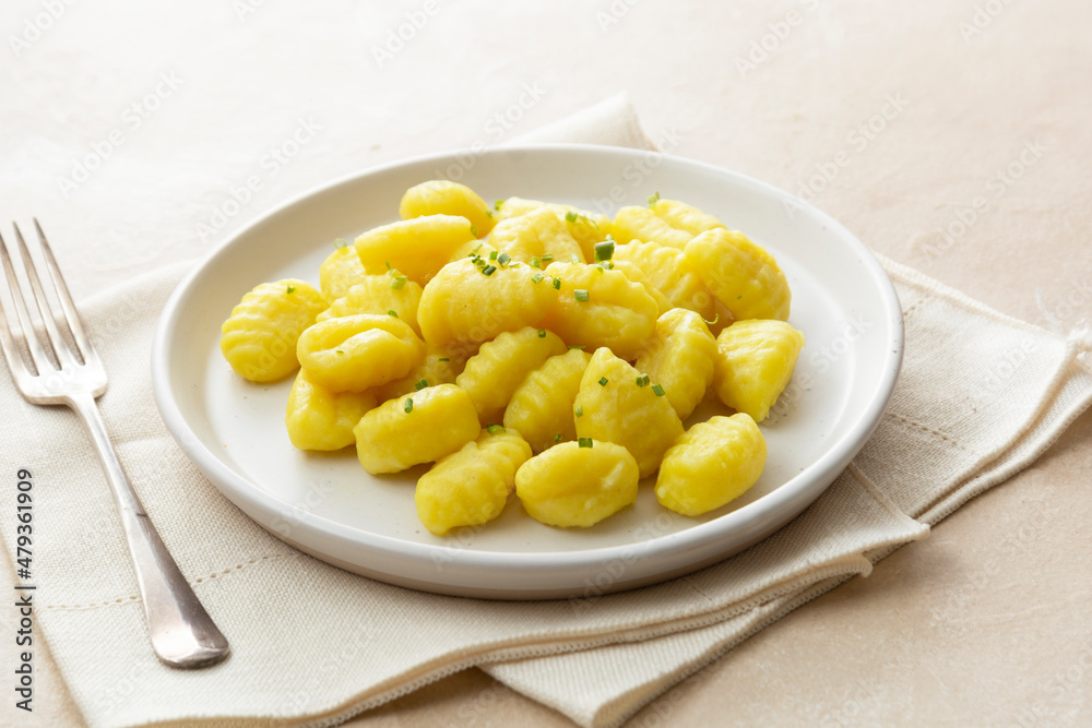 Potato dumplings gnocchi mediterranian food. Cooked gnocchi with butter and green onions.