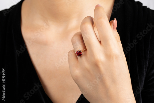Close portrait of female model in gold and silver rings. Isolated on white background . Diamond jewelry. Diamond ring in women's hands