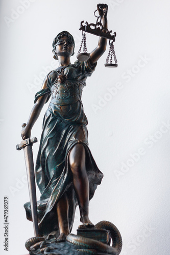 A figure of a temida with a scales in her hand, a sword and a blindfold - a symbol of the law