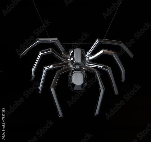 Metal spider weighs on web on black background..