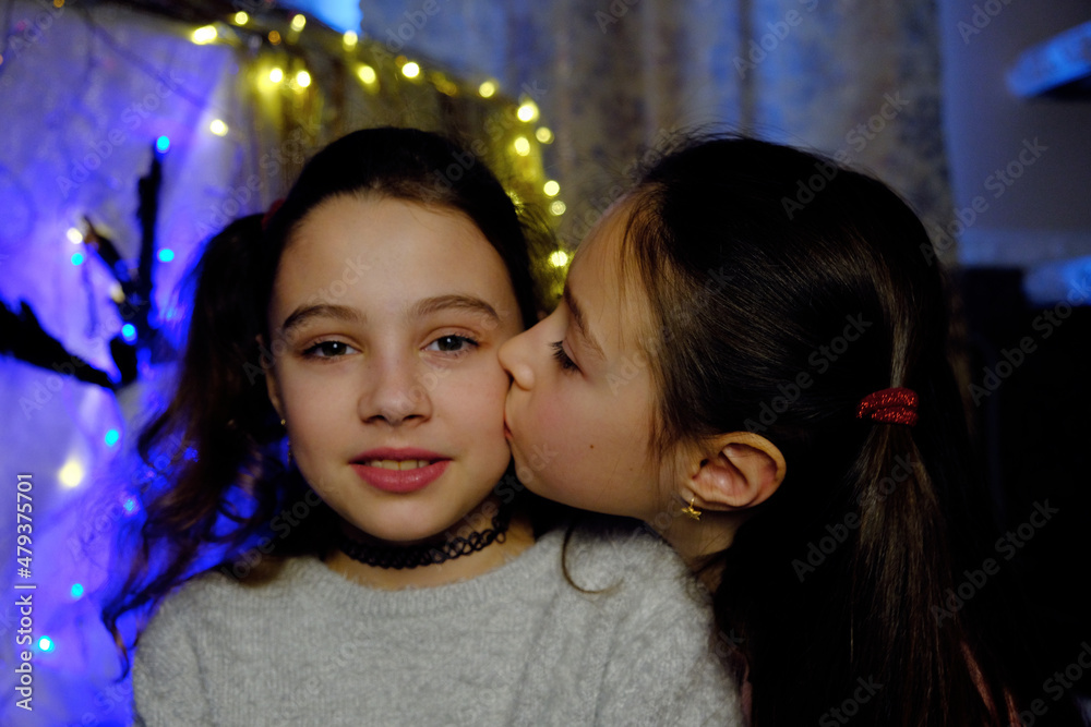 girls sisters, friends, teenagers and friendship concept - happy smiling cute teenage girls hugging and laughing on festive lights background in celebration
girls sisters, friends, teenagers and friendship concept - happy smiling cute teenage girls hugging and laughing on festive lights background in celebration
