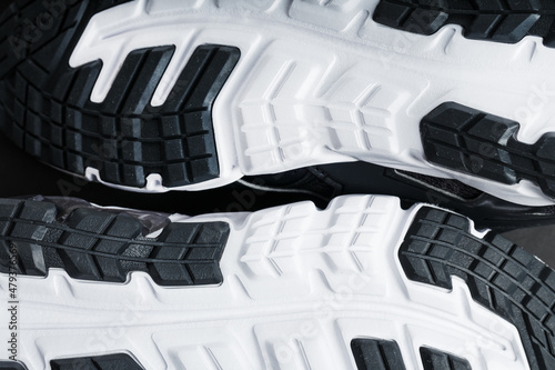 The sole of the sports sneakers for running in black and white close-up