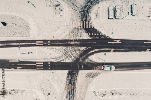 Street intersection in winter, aerial view. Low traffic on snowy winter day
