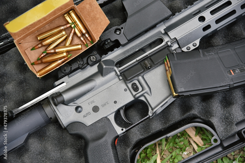 Close-up of a M4A1 (AR-15 model) and 5.56 bullets weapons and military equipment for army, Assault rifle gun on a black case box.