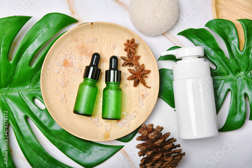 Obraz na płótnie Natural skincare beauty product with spices oil, Cosmetic pump bottle containers packaging with green nature leaves, Blank label for organic spa branding mock-up,Herbal healthy skin care. w salonie