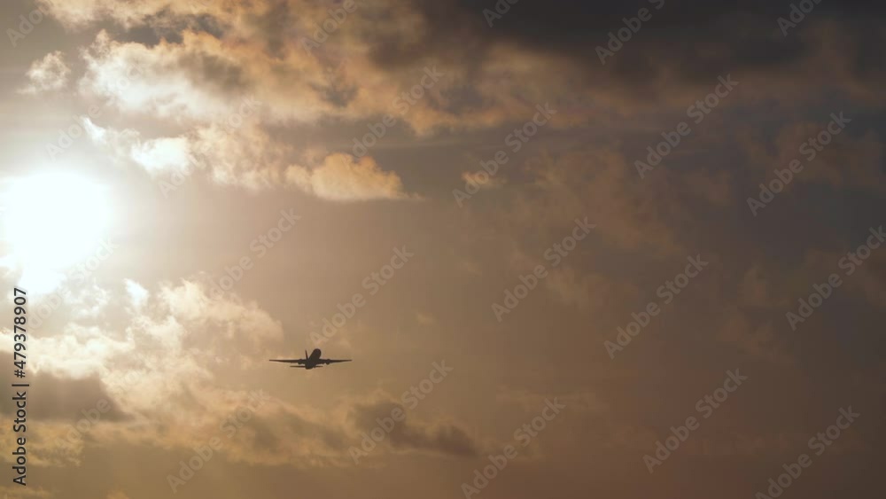 Travel, vacation, transport by air concept. Jet is flying in sunset sky with clouds Travel, vacation, transport by air concept. Jet is flying in sunset sky with clouds