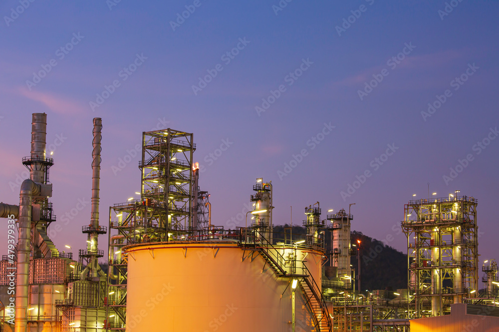 Oil​ refinery​ and​ plant of petrochemistry industry tank oil​ and​ gas​ ​industry with​ cloud​ ​sky the sunset
