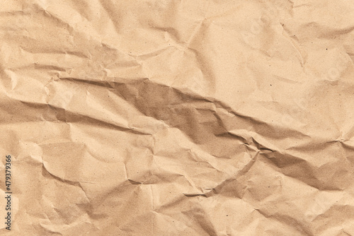Crumpled brown paper texture. Kraft recycled paper background. photo