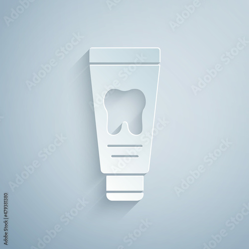 Paper cut Tube of toothpaste icon isolated on grey background. Paper art style. Vector