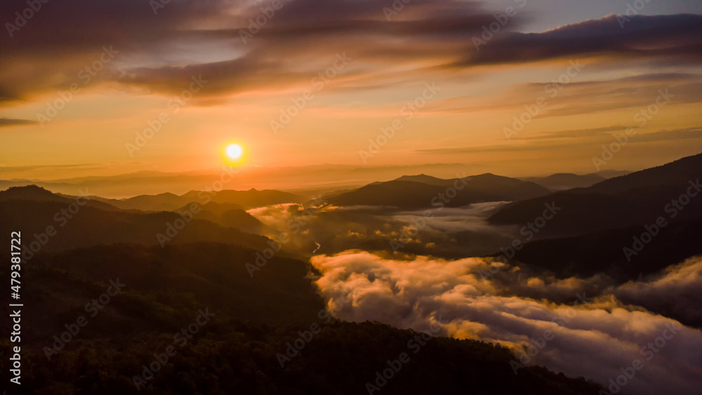 sunset and white mist or cloud scenic aerial view. Flying through the clouds and fog above mountain tops.	