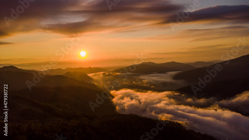 sunset and white mist or cloud scenic aerial view. Flying through the clouds and fog above mountain tops. 