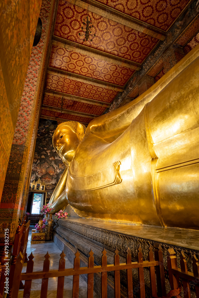 Reclining Buddha statue in Wat Pho, a famous Buddhist temple complex in Bangkok, Thailand.	