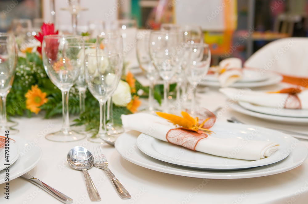 Luxurious table set for a celebration, wedding or event with glassware and cutlery Luxurious table set for a celebration, wedding or event with glassware and cutlery