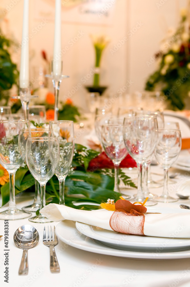 Luxurious table set for a celebration, wedding or event with glassware and cutlery Luxurious table set for a celebration, wedding or event with glassware and cutlery