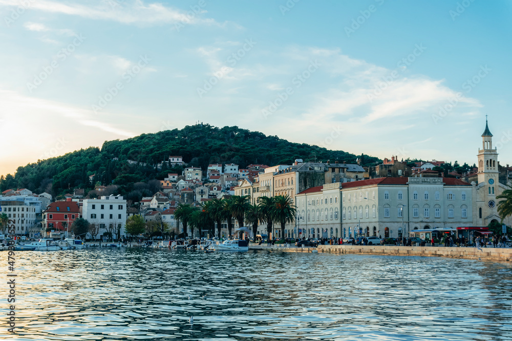 Waterfront of Split city with walking people before sunset. Croatia Waterfront of Split city with walking people before sunset. Croatia