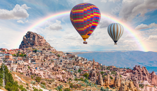 Fotografie, Obraz Hot air balloon flying over spectacular Cappadocia - Girls watching hot air ball