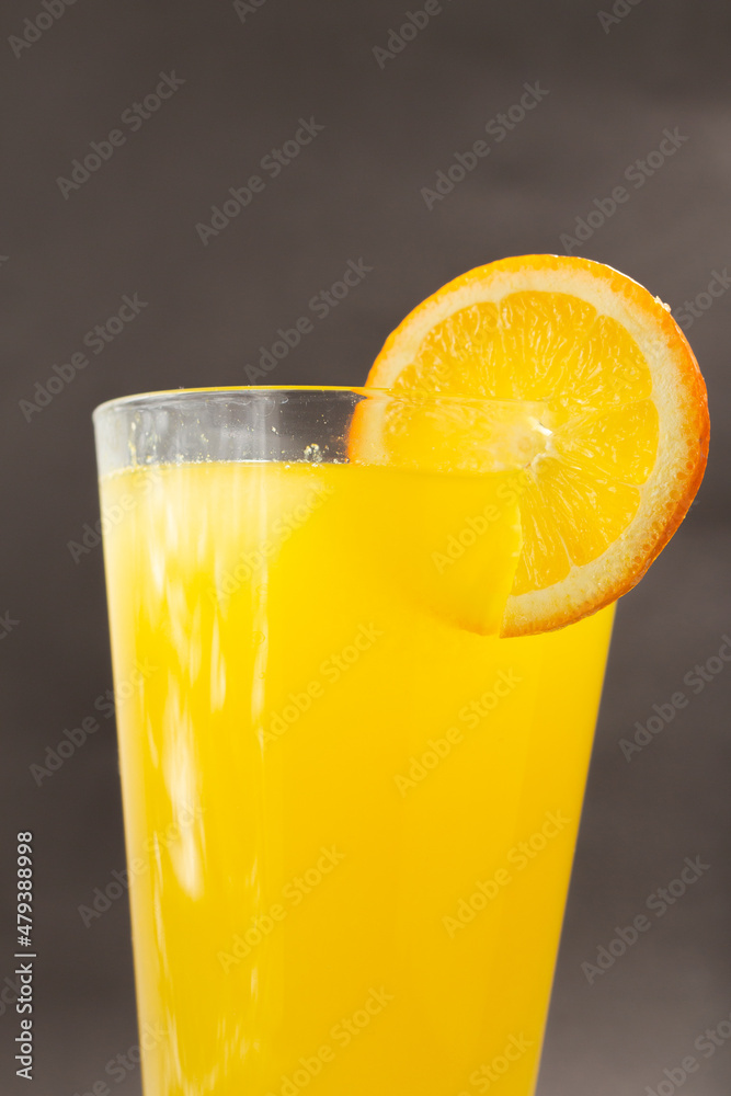 Glass of fresh orange juice with fruits cut in half and sliced isolated on gray background, clipping path Glass of fresh orange juice with fruits cut in half and sliced isolated on gray background, clipping path
