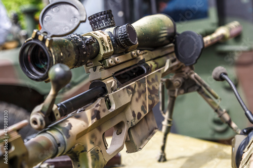 Modern powerful sniper rifle with a telescopic sight mounted on a bipod.Elements of the sniper rifle with tactical body .