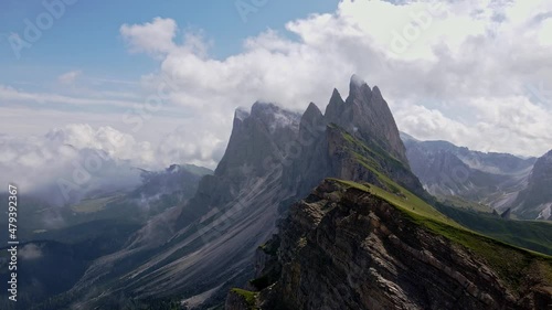 Seceda mountain surrounded with clouds. Cloudy mountain.Magical drone shot of italian dolomites. Summer in the mountains. 