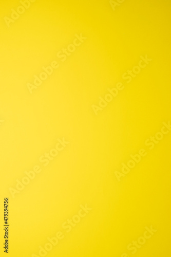 plain texture of a yellow gradient, vertical image, empty background © Rufino