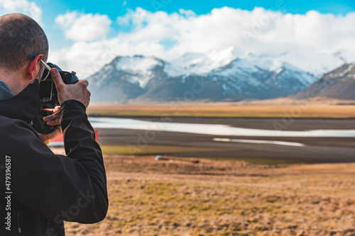 Man photographer and explorer in Iceland taking photos of beautiful landscape