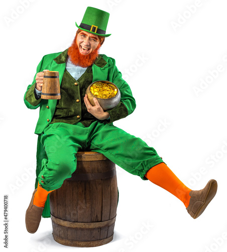 Leprechaun elf on St. Patrick's Day. Cheerful character Irish leprechaun for advertising with a red natural beard in a green suit and green hat for advertising. Cosplay at the festival on March 17th photo