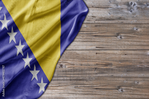Wooden pattern old nature table board with Bosnia and Herzegovina flag
