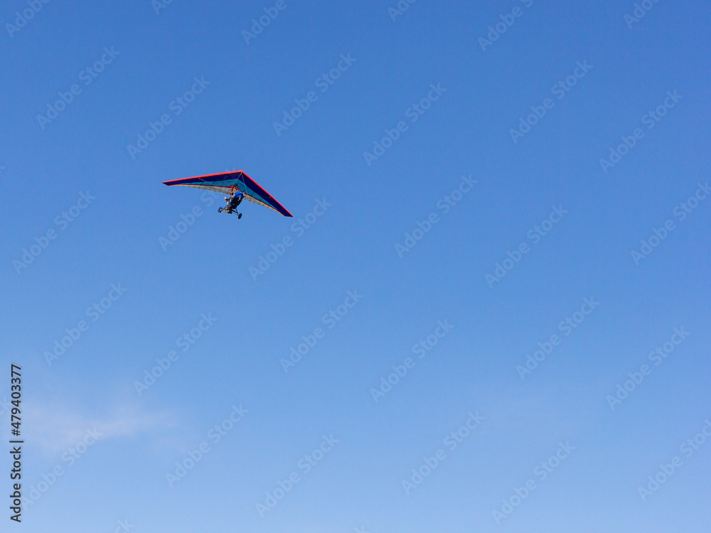 Flying a motorized hang glider on an autumn sunny day. Flying a motorized hang glider on an autumn sunny day.