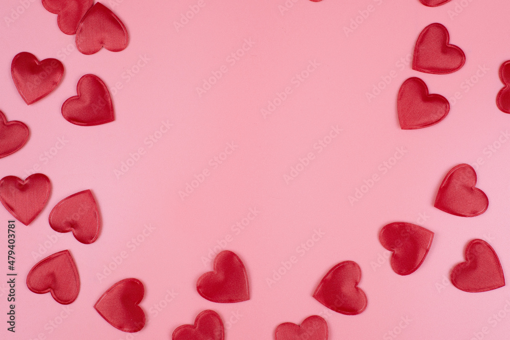 red hearts on a pink pastel background. Abstract background with paper-cut shapes. Sainte Valentine, mother's day, birthday greeting cards, invitation, celebration concept