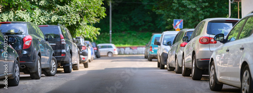 City traffic with cars parked in line on street side