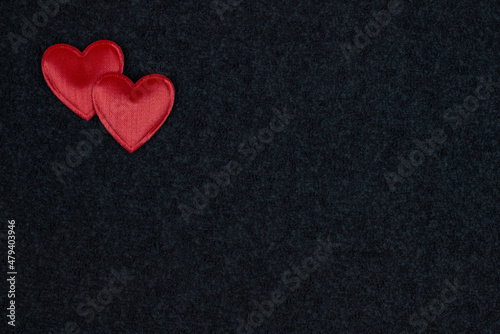 Red hearts on black background with copyright space for text