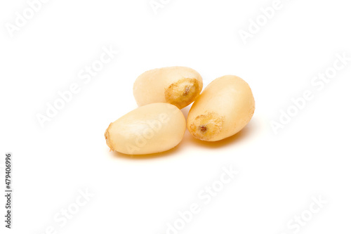 Siberian peeled pine nuts isolated on white background. Healthy nuts snacks. Clipping path, full depth of field. Closeup view.