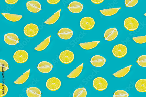 Fruit seamless pattern of lemon slices on a vivid blue background. Tropical organic fruit, citrus, vitamin C. Lemon slices.