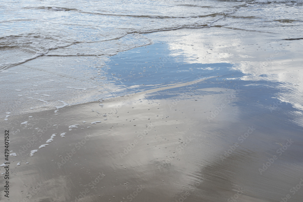reflection of clouds in sea water on the sandy beach mediterranean coast background reflection of clouds in sea water on the sandy beach mediterranean coast background