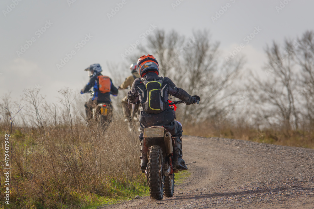 a motor cyclist (biker) riding their off-road motorbike along a stone track on Salisbury Plain, Wiltshire a motor cyclist (biker) riding their off-road motorbike along a stone track on Salisbury Plain, Wiltshire