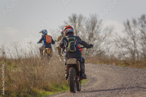 a motor cyclist (biker) riding their off-road motorbike along a stone track on Salisbury Plain, Wiltshire