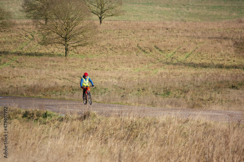 a casual cyclist on a stone track crossing salisbury plain, Wiltshire UK