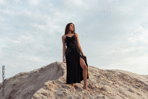 Tanned brunette in the sand dunes