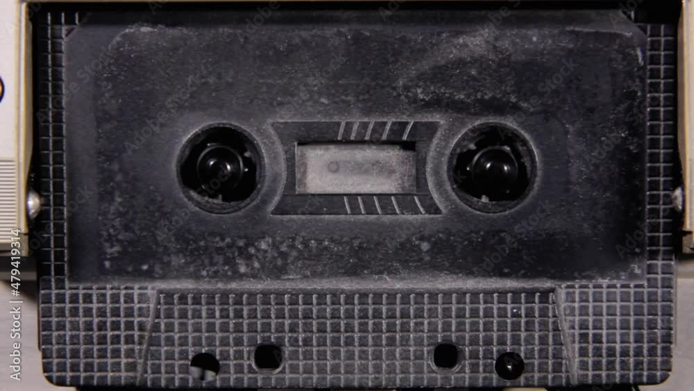 Video Stock Stopping and removing an old black unlabeled cassette tape