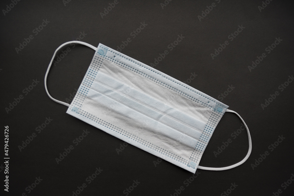 Medical mask isolated on background. Close-up of Coronavirus or COVID-19 protective face mask. Workwear prevents entry of Alpha, Beta, Gamma, Delta, Omicron into a body. Travel rules tightened over Medical mask isolated on background. Close-up of Coronavirus or COVID-19 protective face mask. Workwear prevents entry of Alpha, Beta, Gamma, Delta, Omicron into a body. Travel rules tightened over