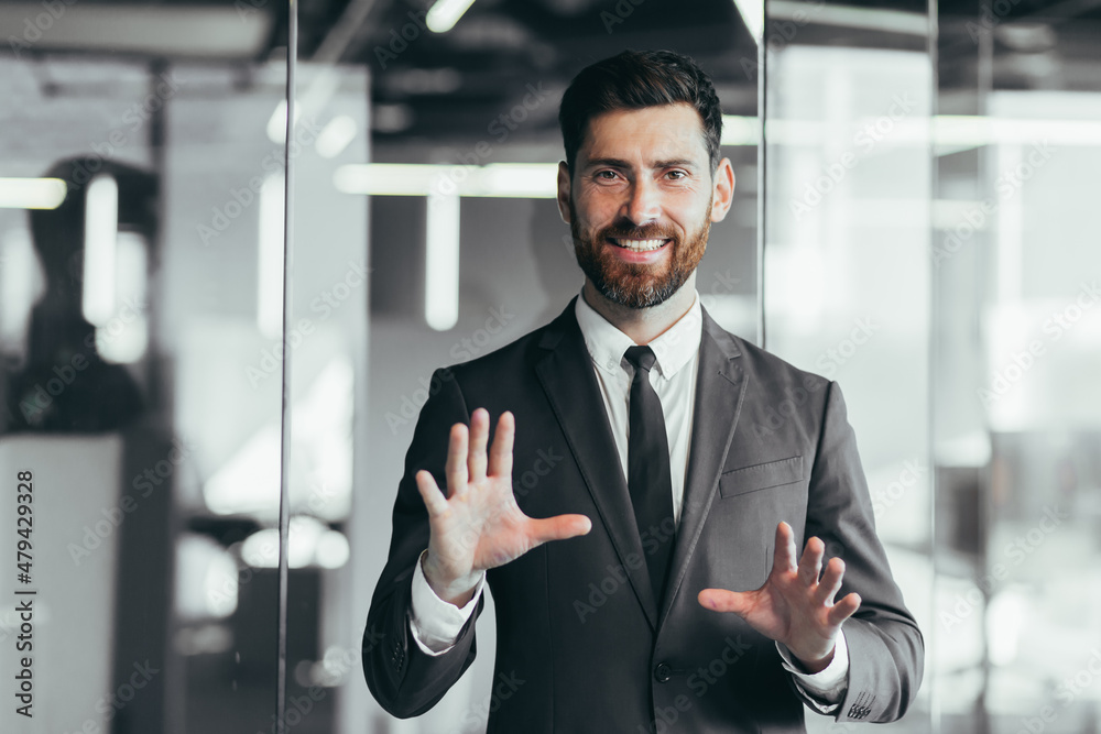 Fototapeta premium Businessman looking at camera and talking on video call, having fun gesturing with hands, webcam view