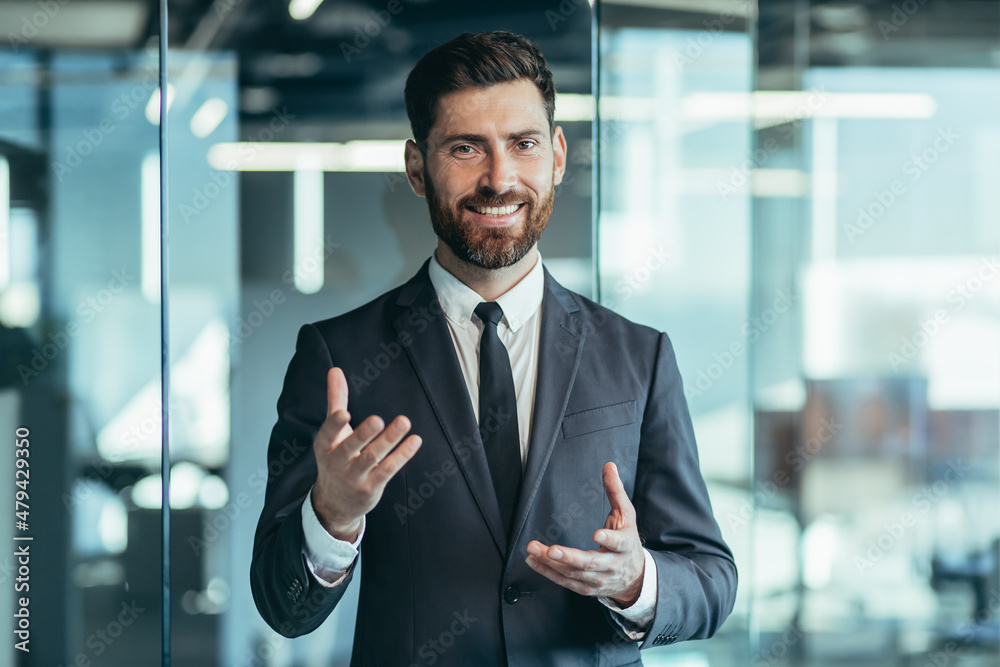 Businessman looking at camera and talking on video call, having fun gesturing with hands, webcam view Businessman looking at camera and talking on video call, having fun gesturing with hands, webcam view