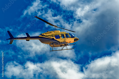 Side view of crop spraying helicopter and clouds