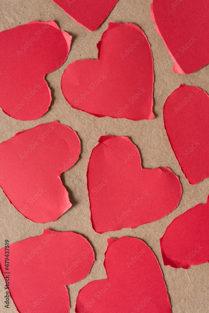 Fototapeta premium torn paper hearts on plain brown paper