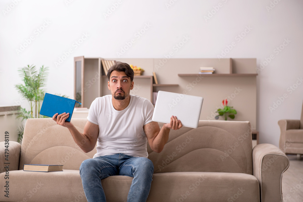 Young male student studying at home during pandemic Young male student studying at home during pandemic