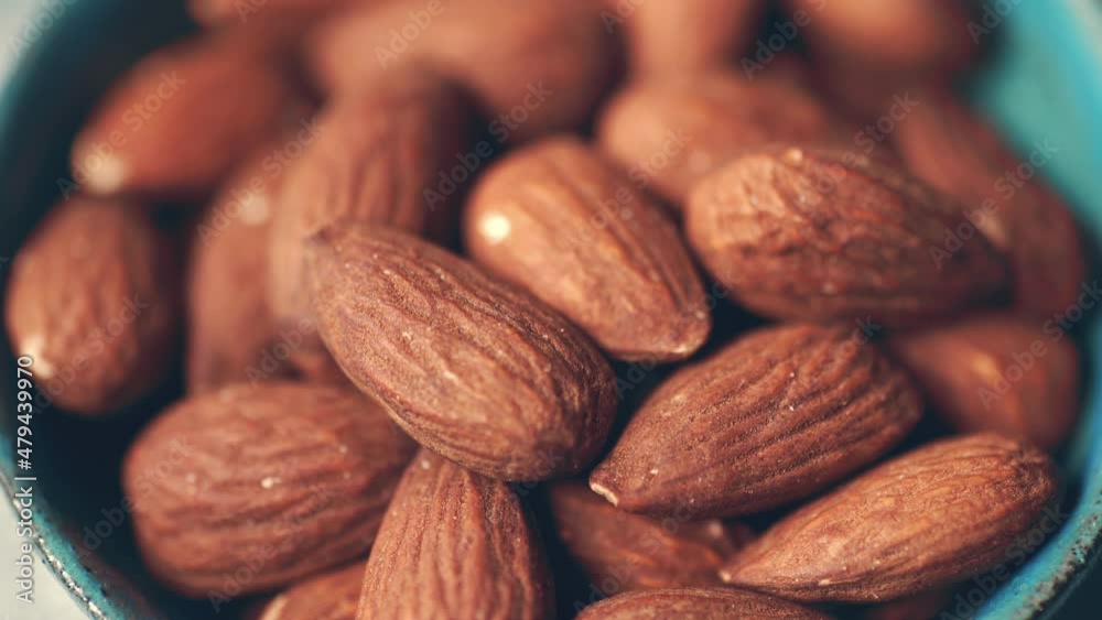 Almond Nuts in plate macro shot with selective focus. Healthy organic nutrition eating. Almond Nuts in plate macro shot with selective focus. Healthy organic nutrition eating.
