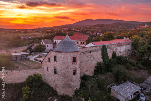 Fotografie, Obraz Aerial sunset shot of Pecsvarad fortified church, abbey  and castle with tower,