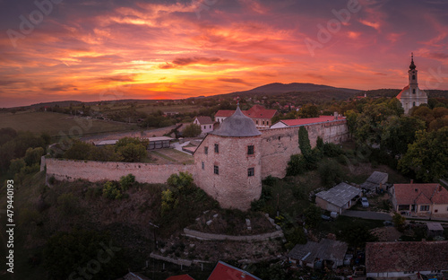 Fotografie, Obraz Aerial sunset shot of Pecsvarad fortified church, abbey  and castle with tower,