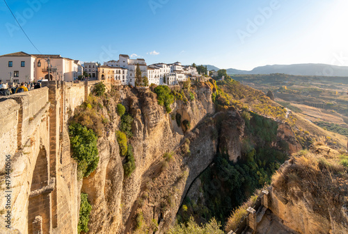 View of the medieval hillside town from one of the cono balconies overlooking the gorge, bridge and canyon valley in Ronda, Spain 