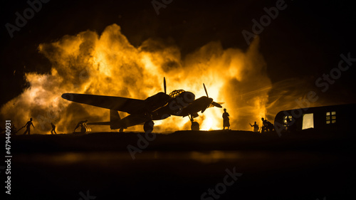 German Junker (Ju-88) night bomber at night. Artwork decoration with scale model of jet-propelled plane in possession. Toned foggy background with light. War scene. photo